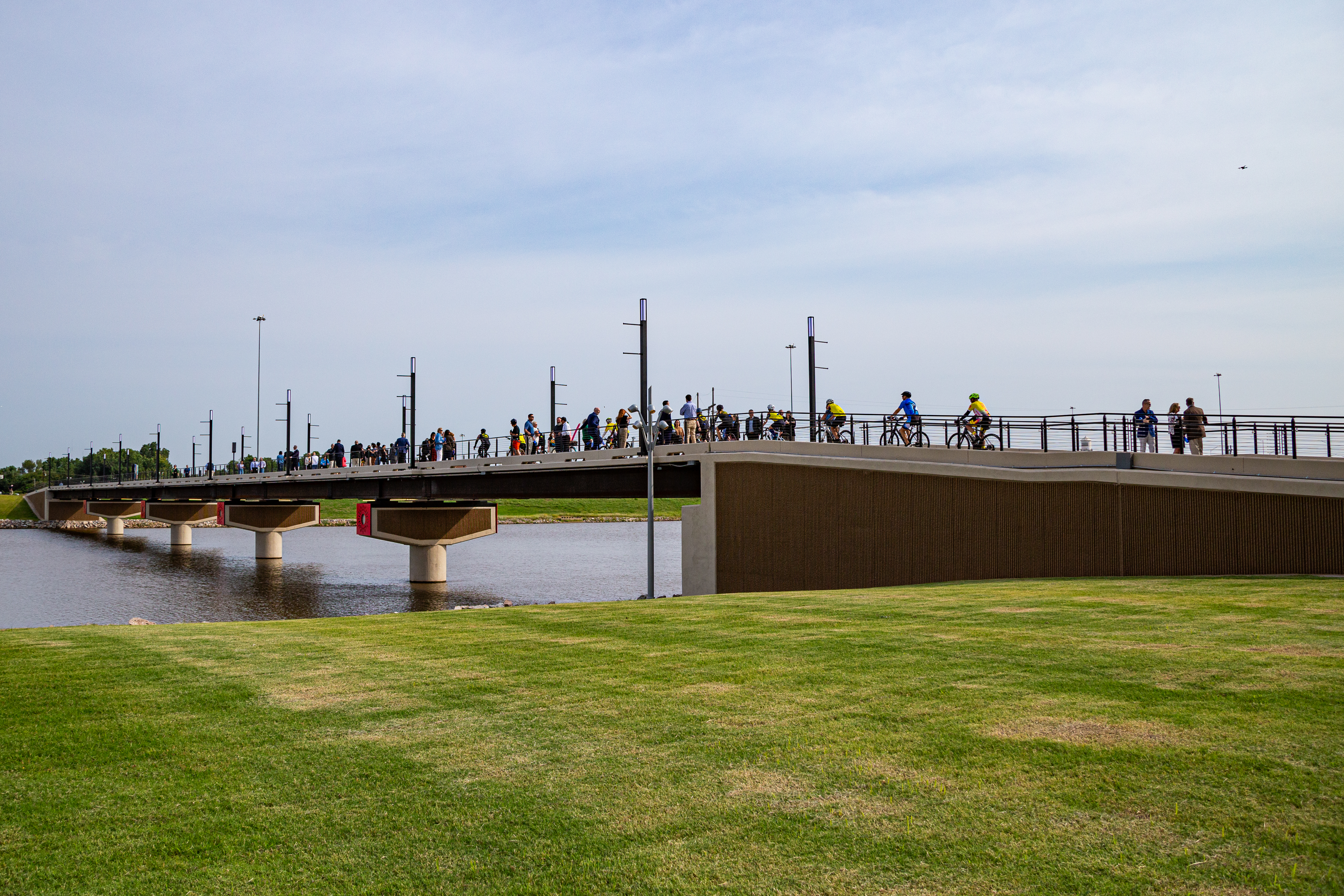 dozens of people walking on newly installed pedestrian bridge