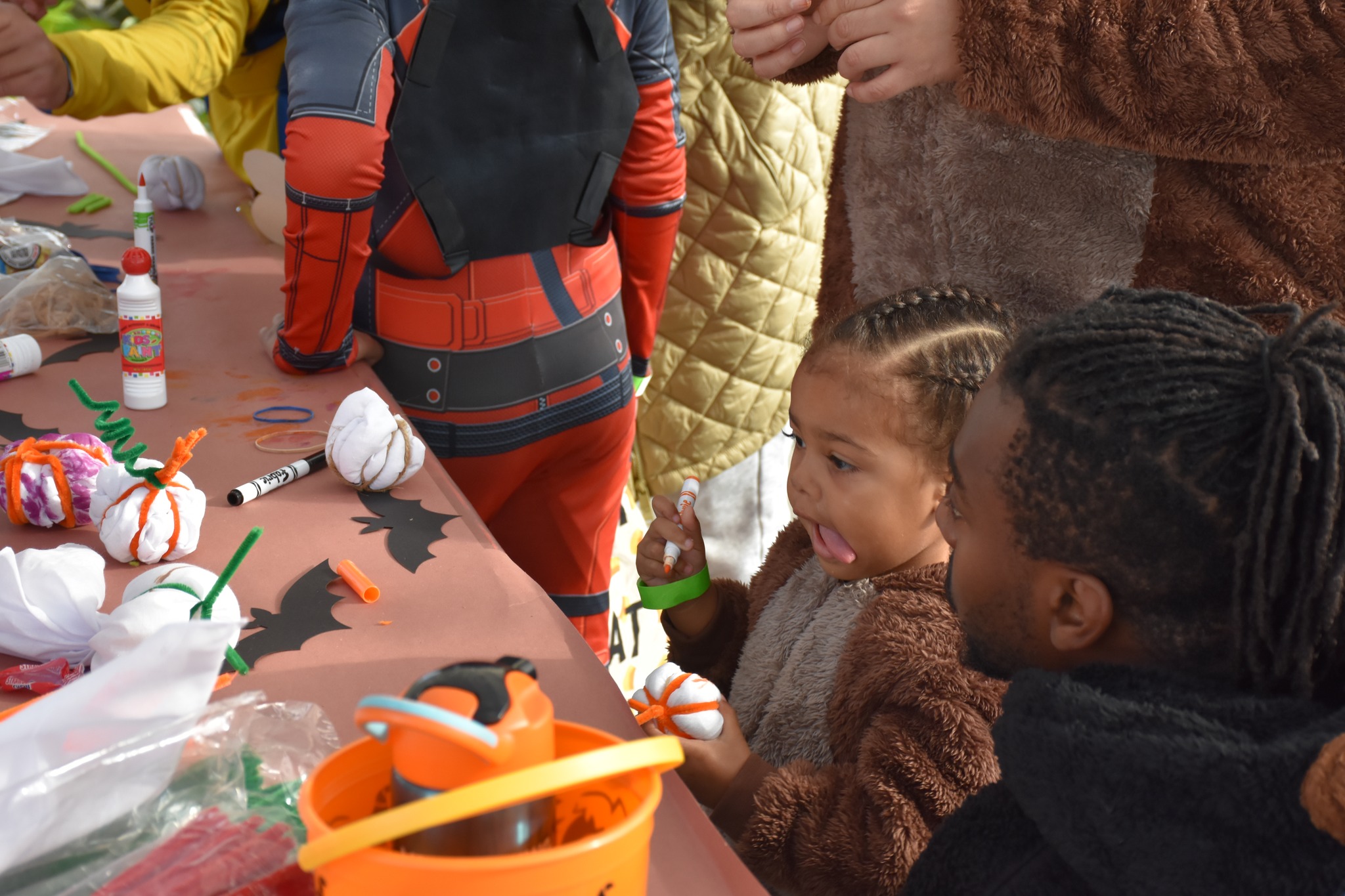 Young child and parent at halloween arts and craft table