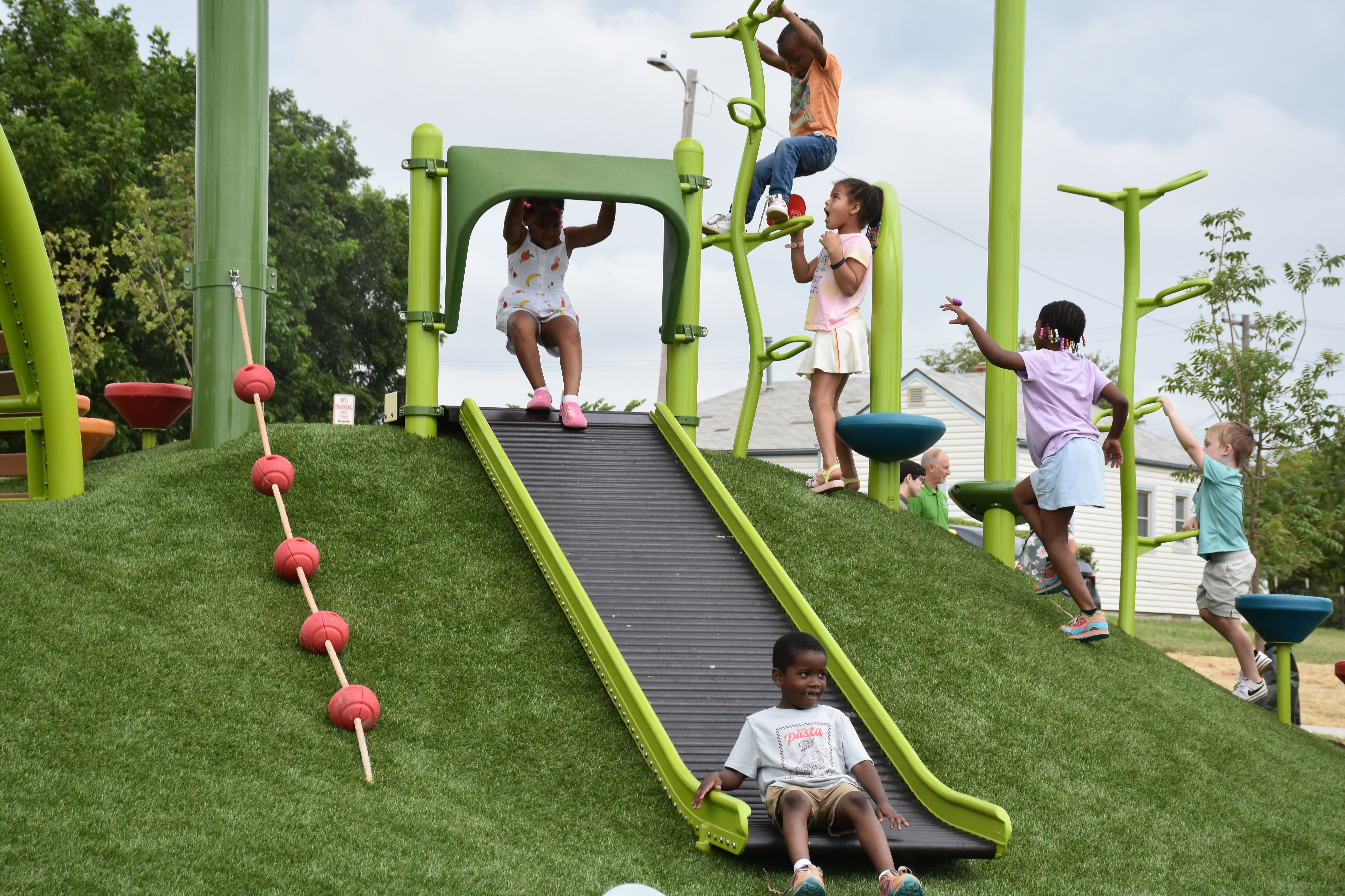 kids playing on new playground equipment