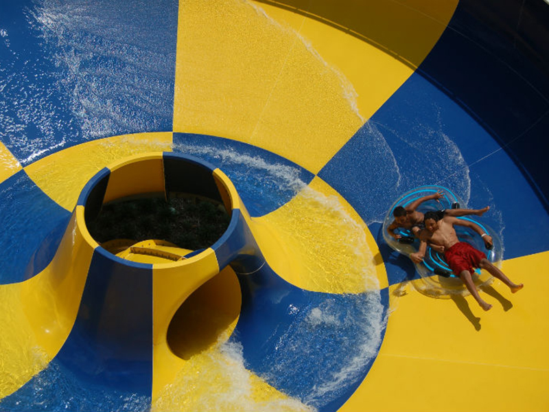 kid on tube in water funnel slide