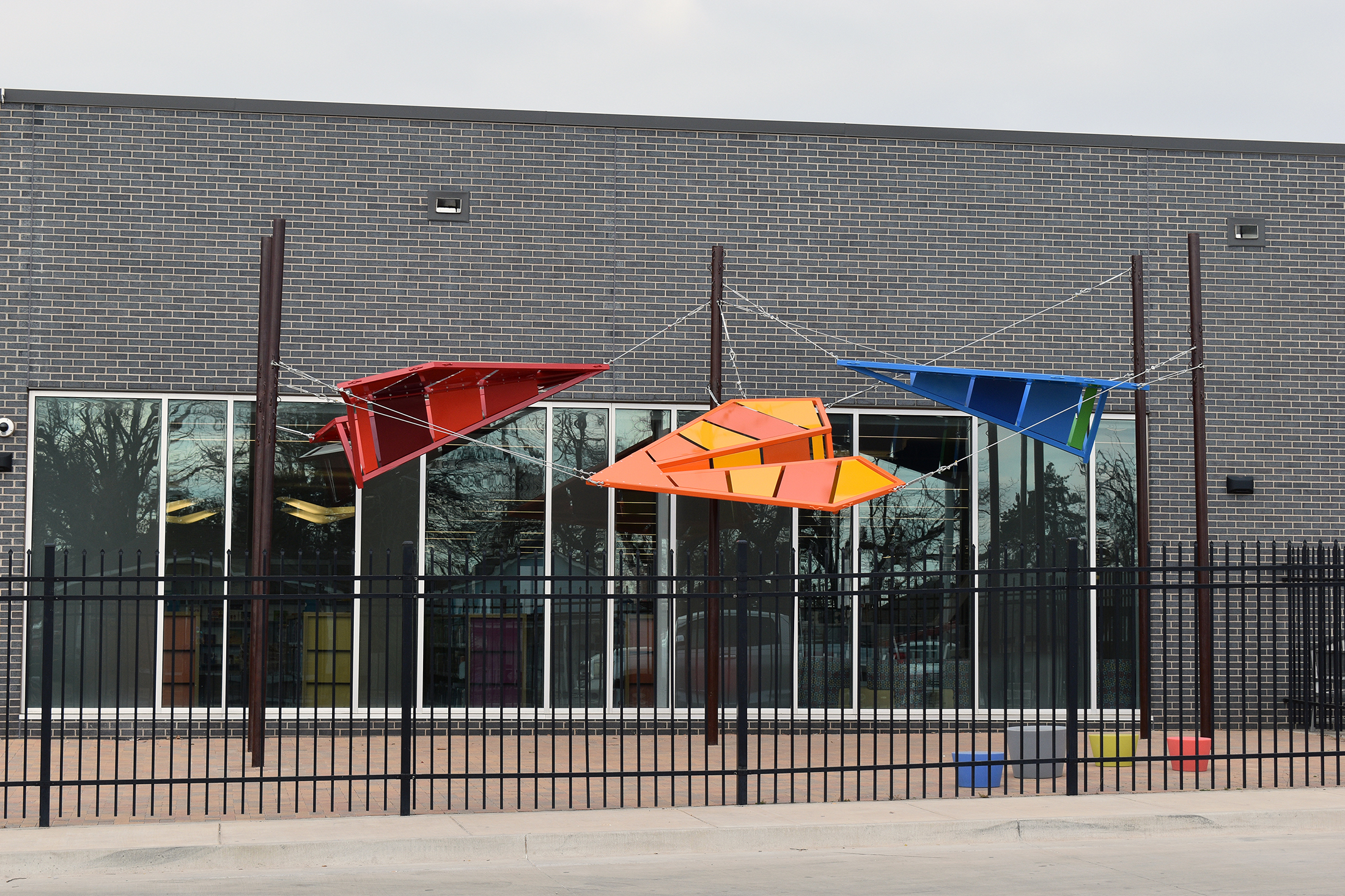 sculptures of kites outside building