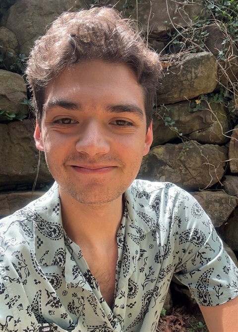 selife of young guy wearing green pattern shirt