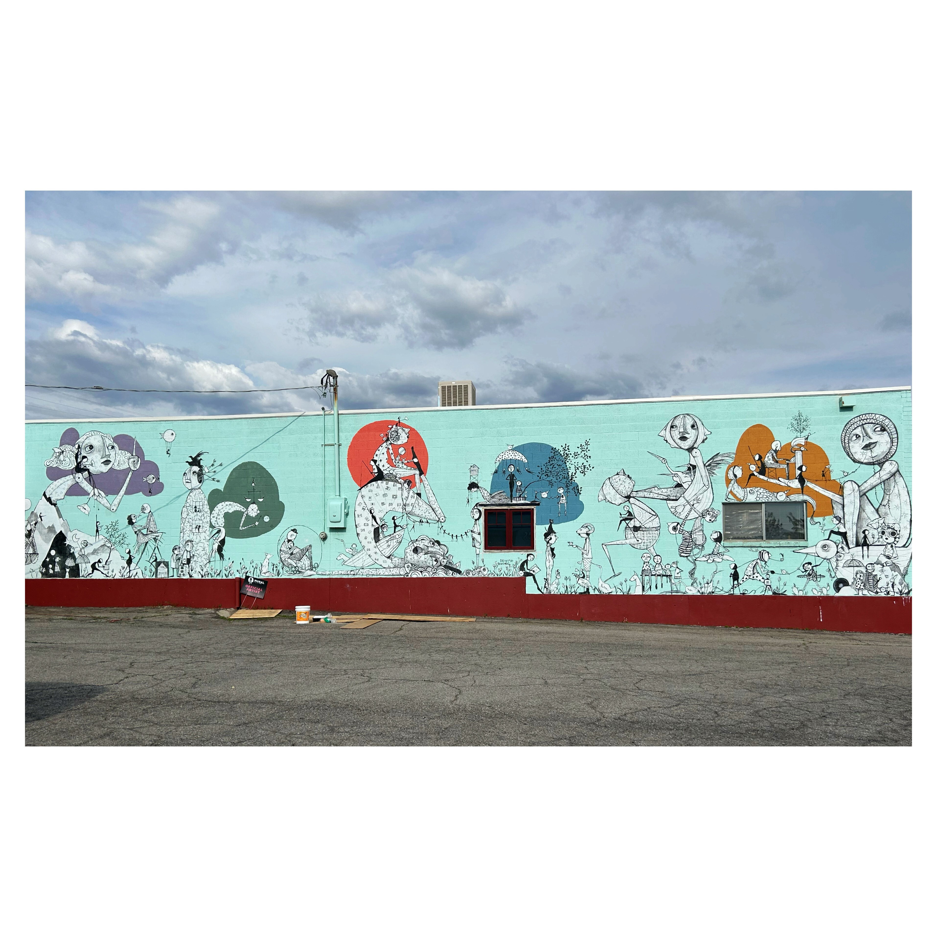 graphics of people on sea foam background on side of building