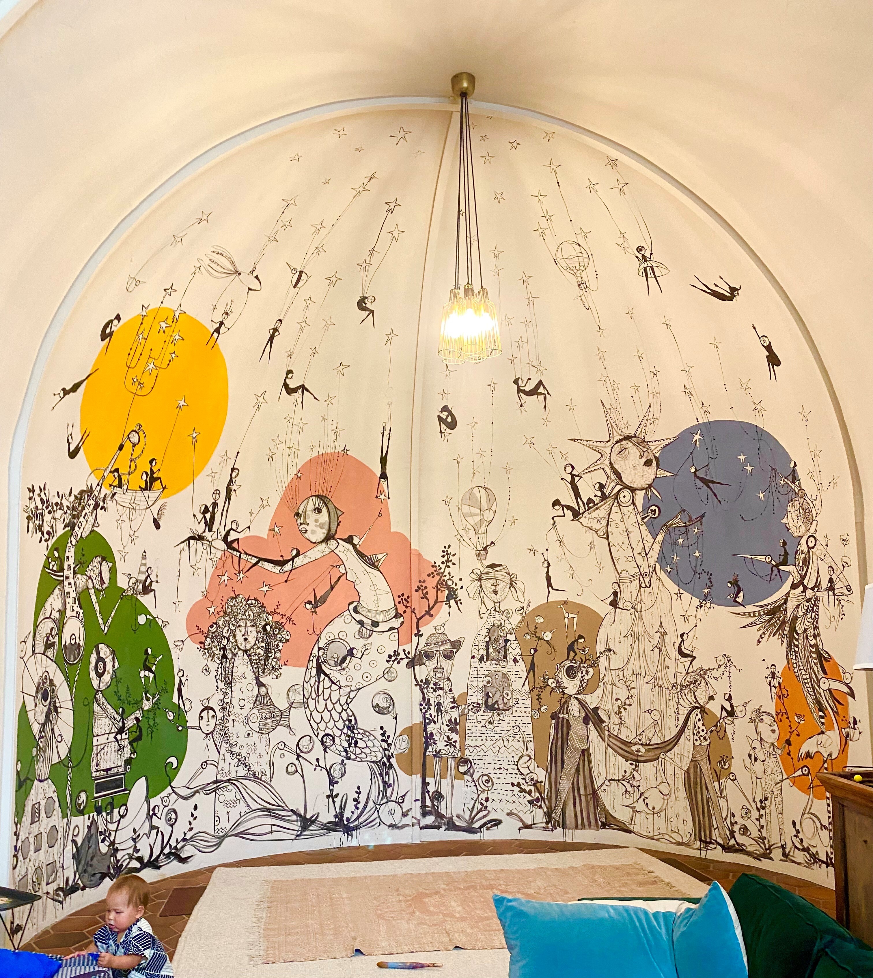 curved room with mural of human like creatures in different scenes