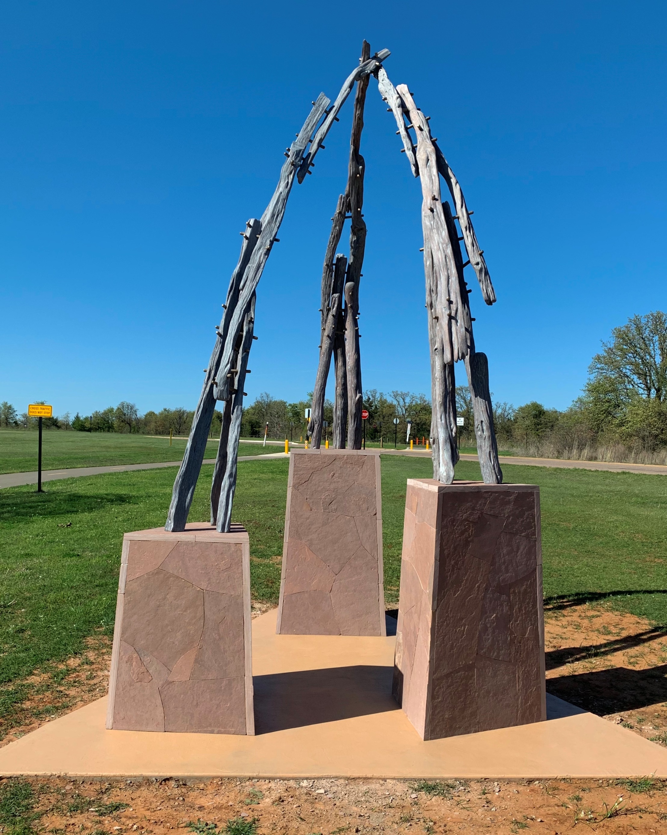 three branches meeting on stone pedestals