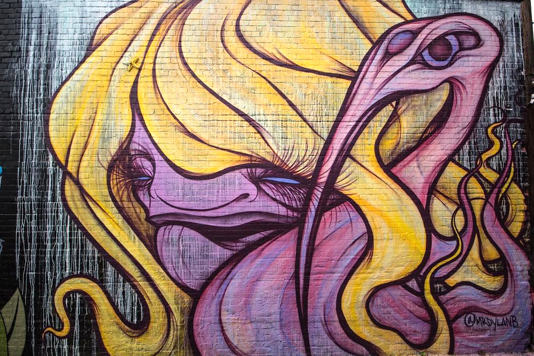 creature with purple body and yellow hair mural
