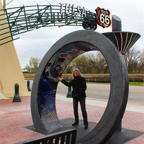 woman standing under circular mosaic art