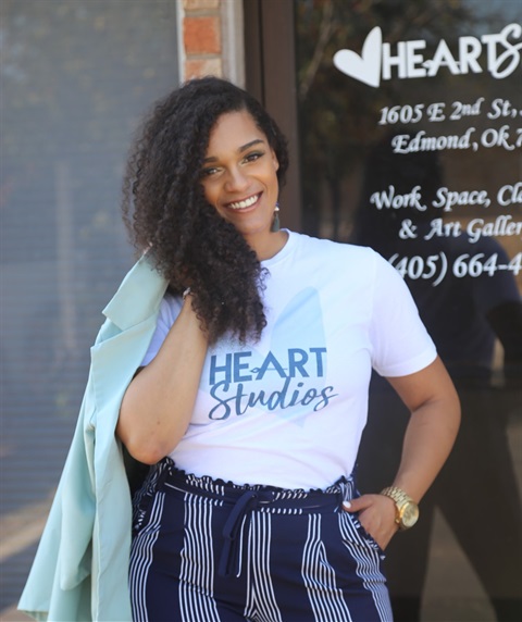 young black woman holding jacket over her shoulder