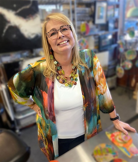woman in colorful duster leaning on counter
