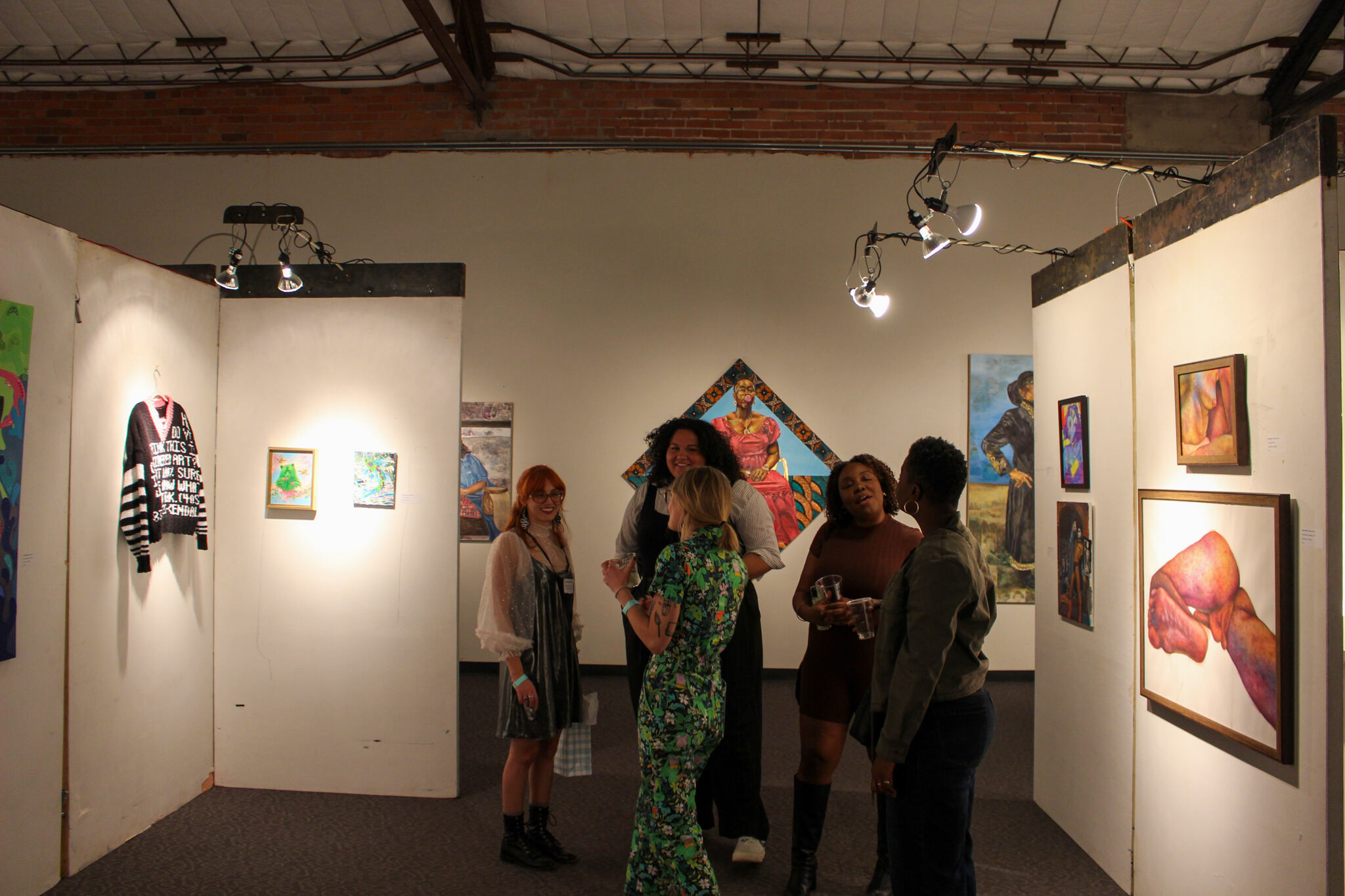people mingling in art exhibit