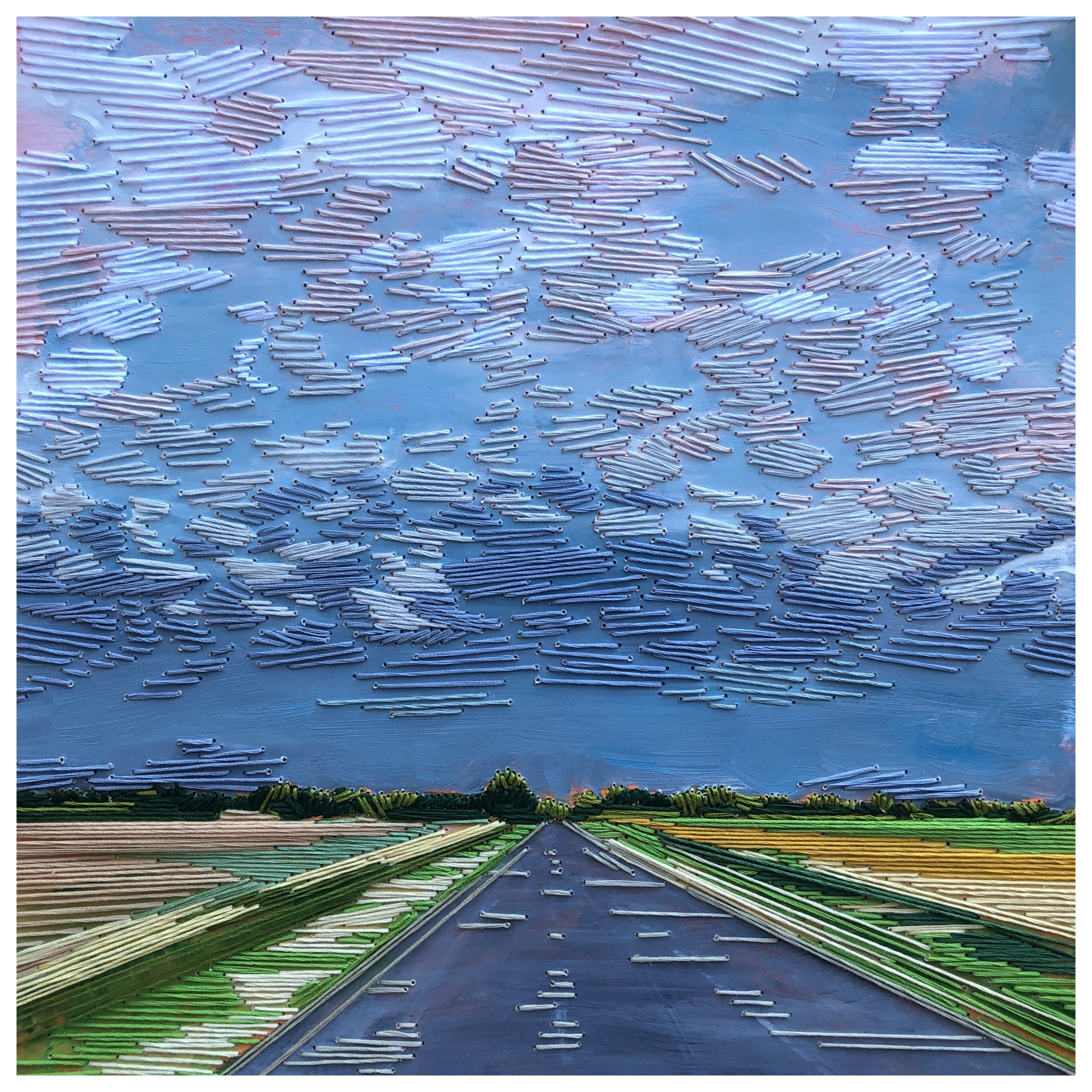fiber art scene of long road next to fields