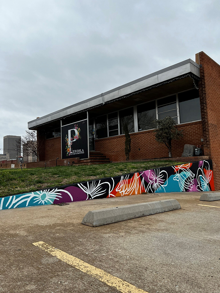 floral mural on retaining wall outside of building