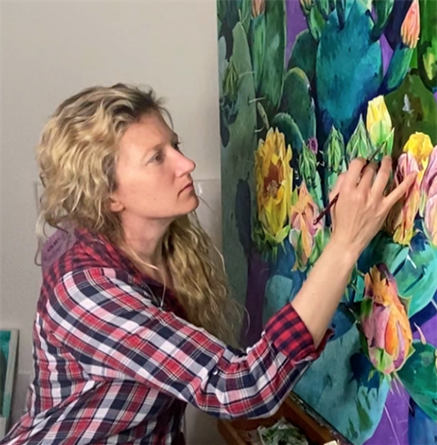 blonde woman in plaid shirt painting cacti