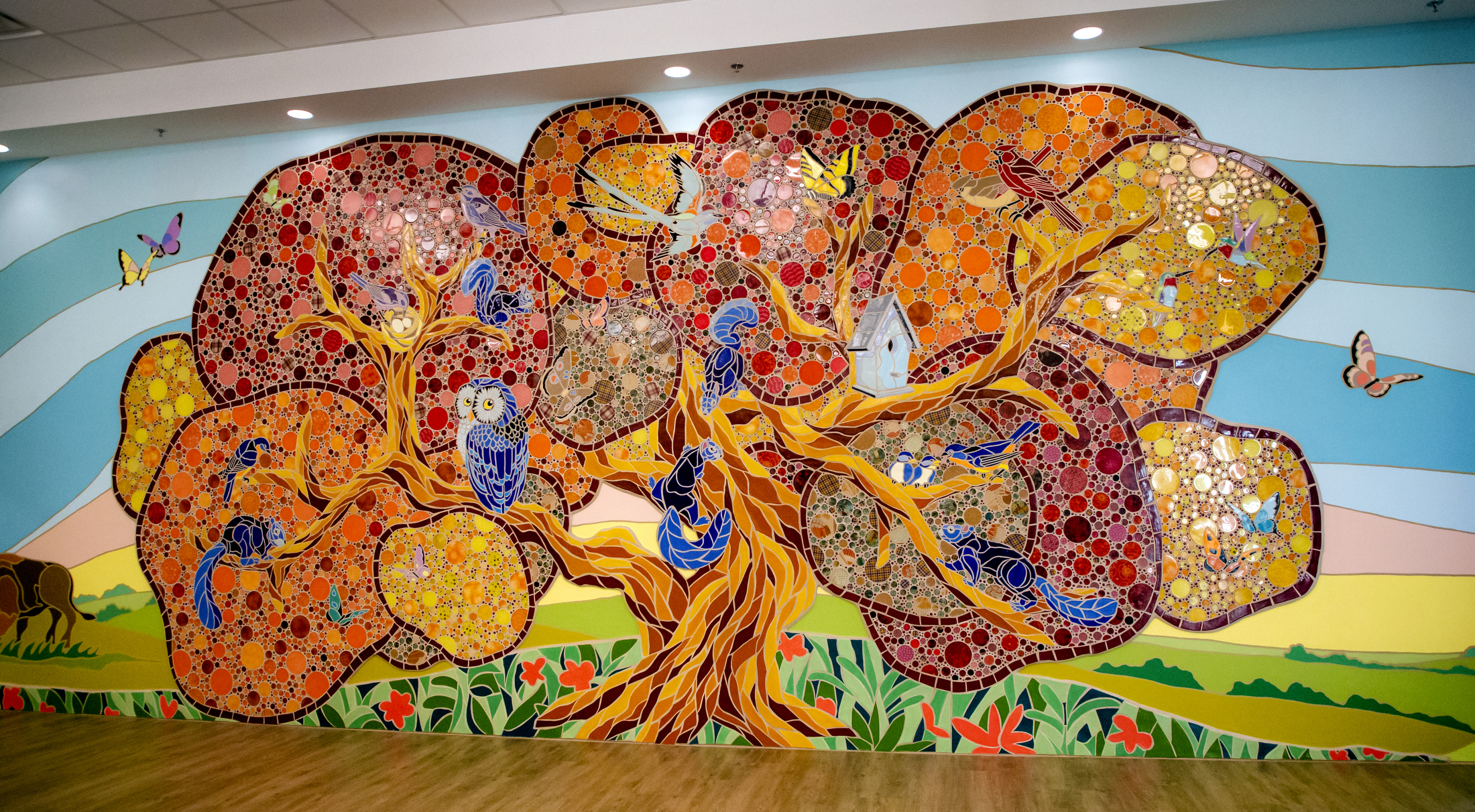 cermaic mosaic of tree, birds and butterflies