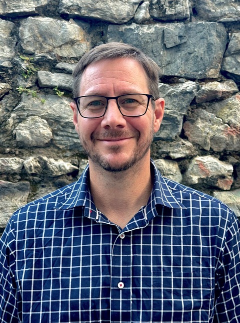 white guy in glasses and blue plaid shirt