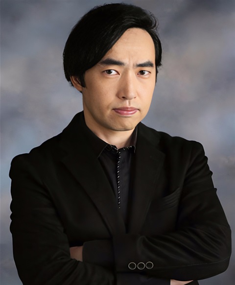 headshot of younger asian man wearing all black