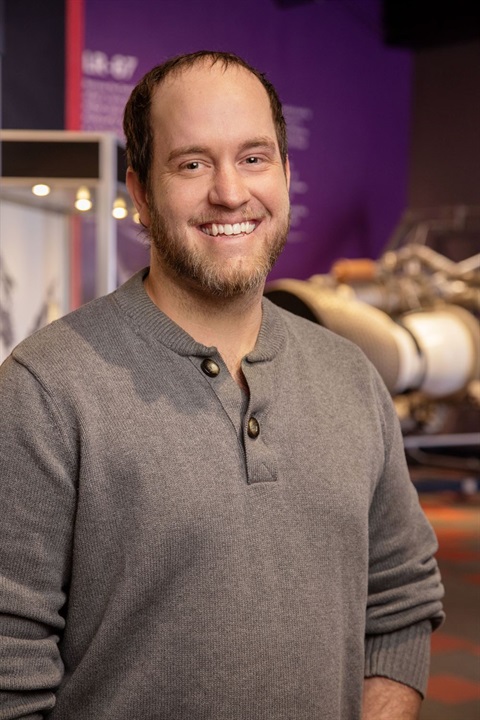 white guy with brown beard smiling