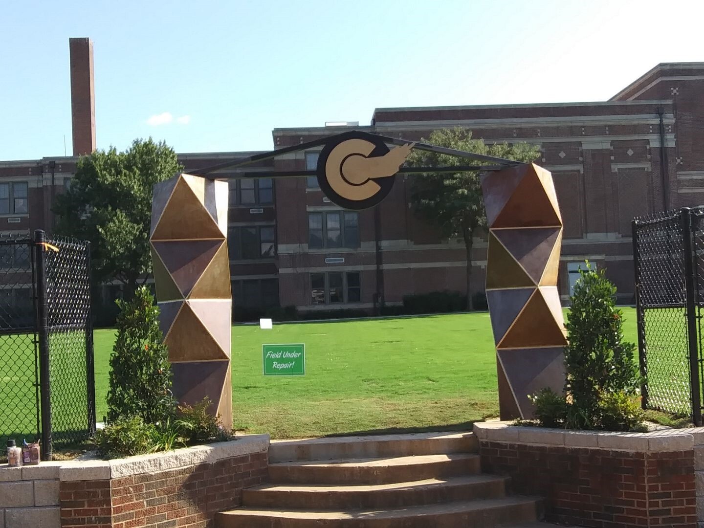 two large columns leading up to a school