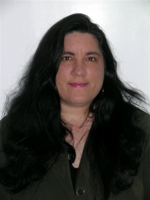 woman with long black hair and black blouse