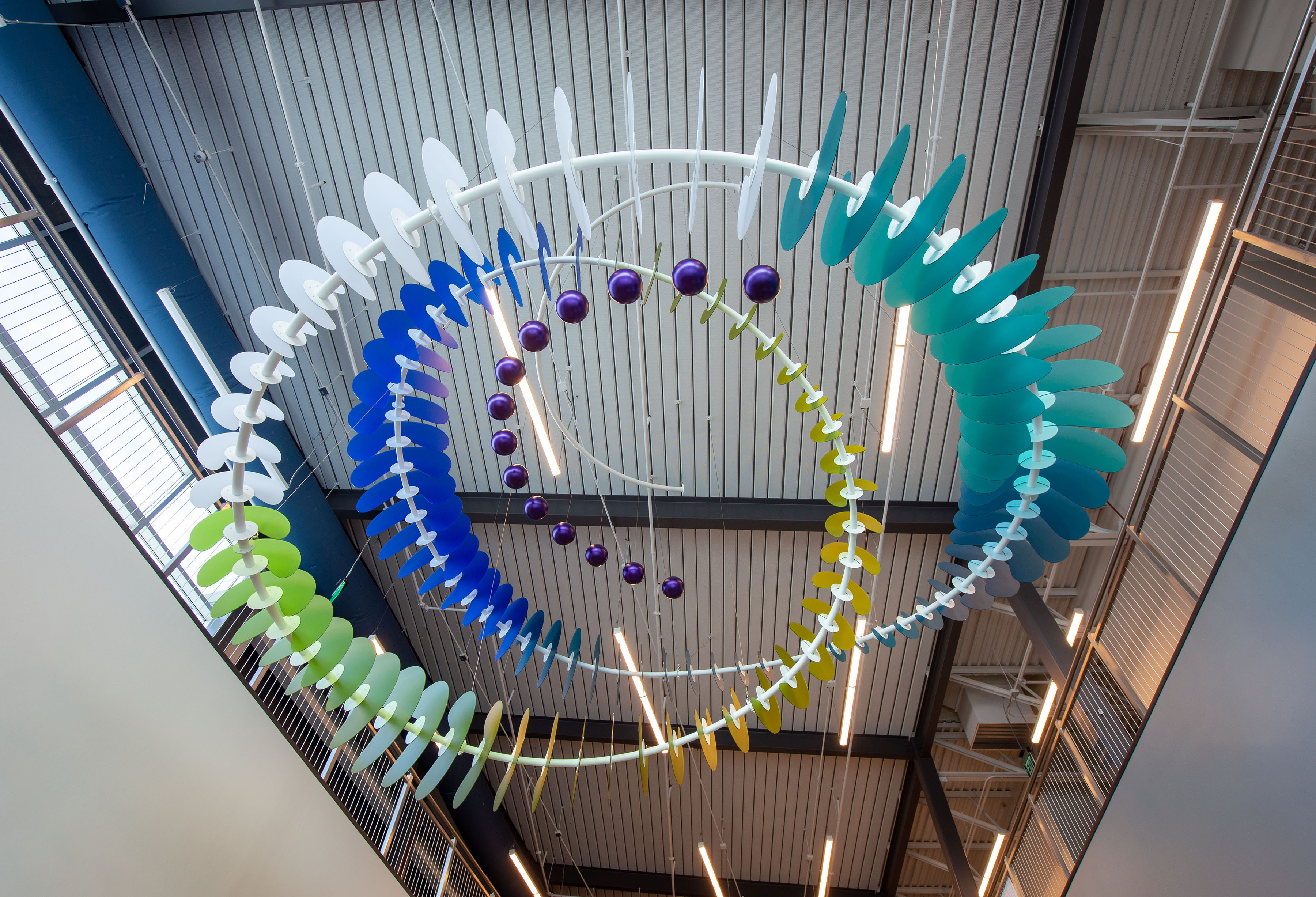 multi colored resin circles to create large circles hanging from the cieling