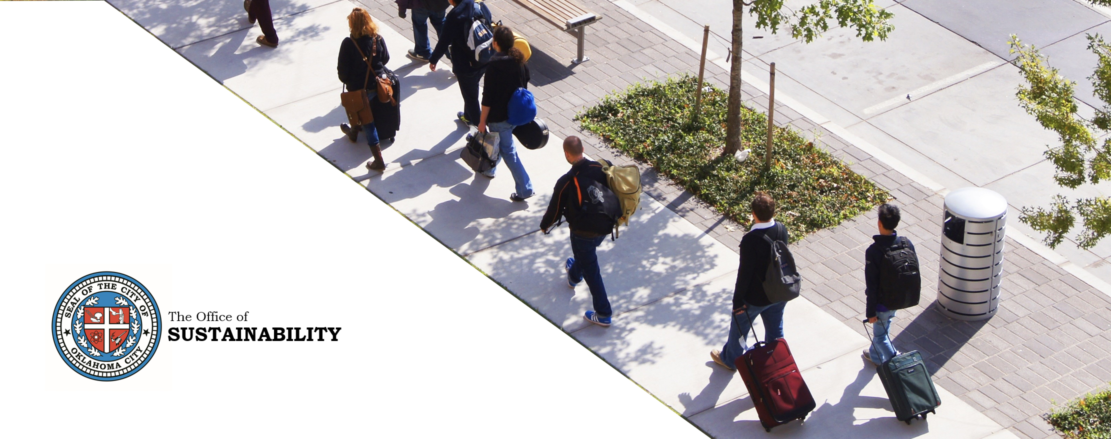 A group of people walking down a sidewalk in downtown Oklahoma City. The City seal is in the left corner.