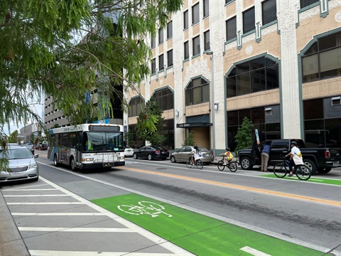 family riding bikes in downtown okc bike lane