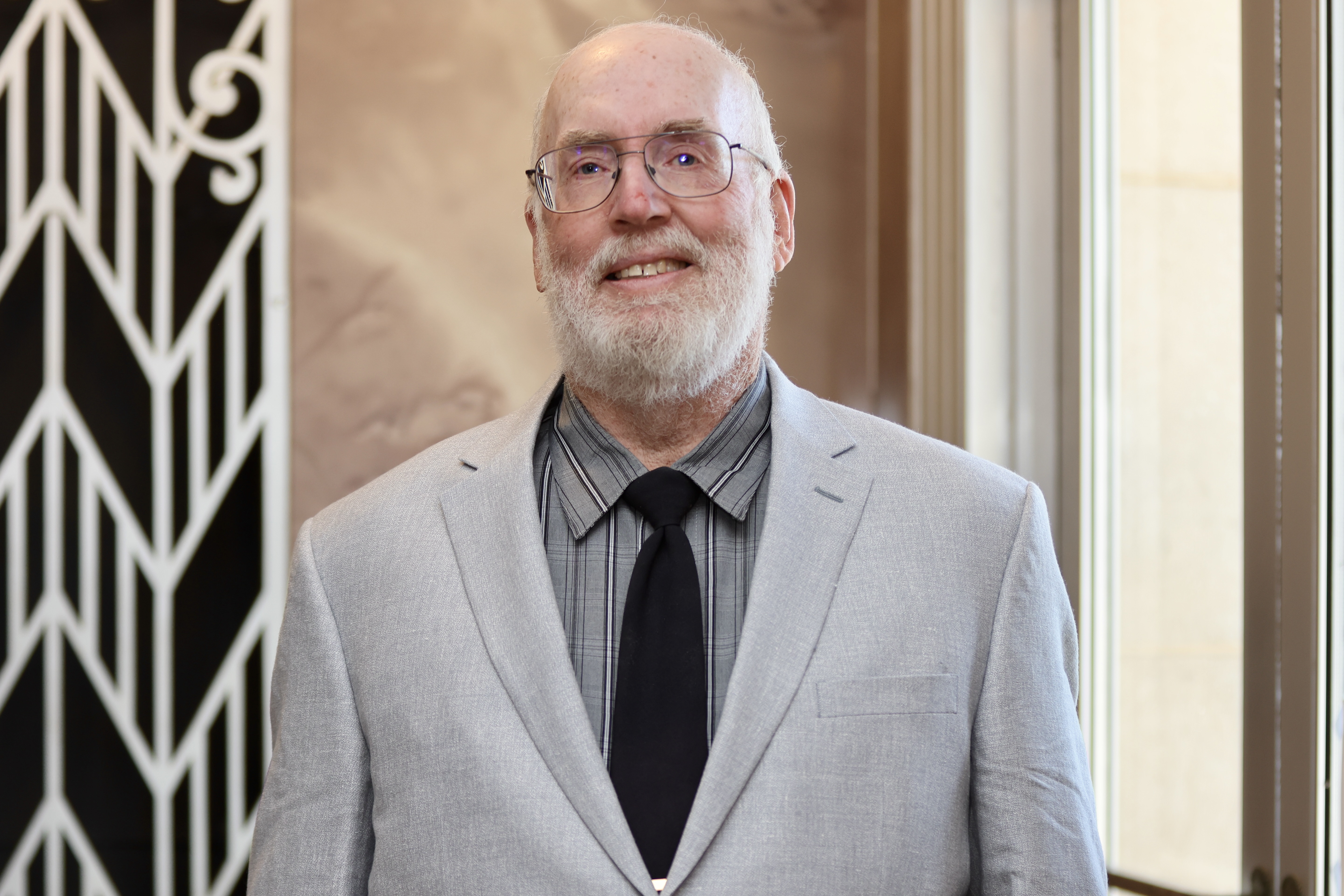 kenny liles wearing gray suit with black tie