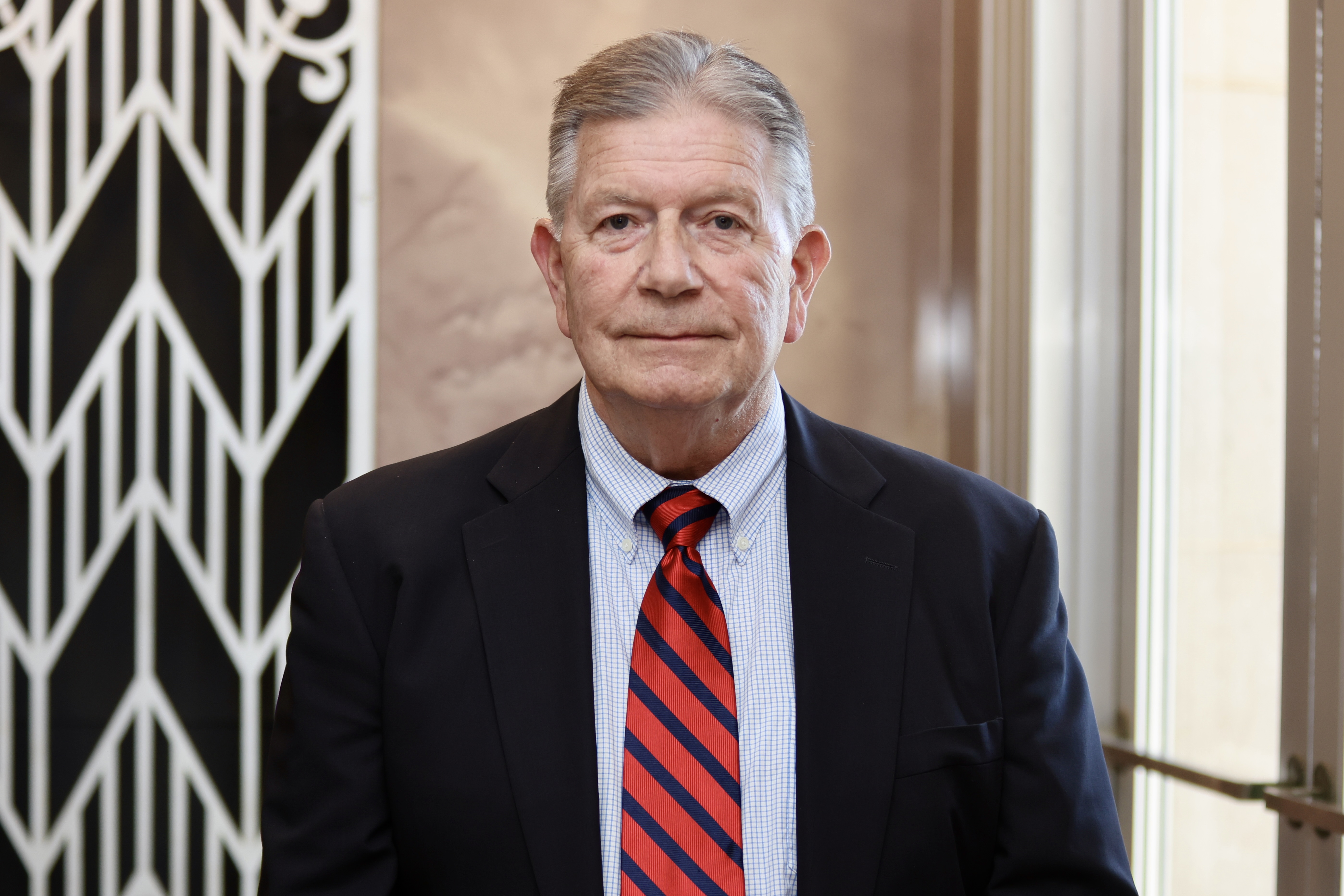 William-Teater wearing black jacket and stripped tie